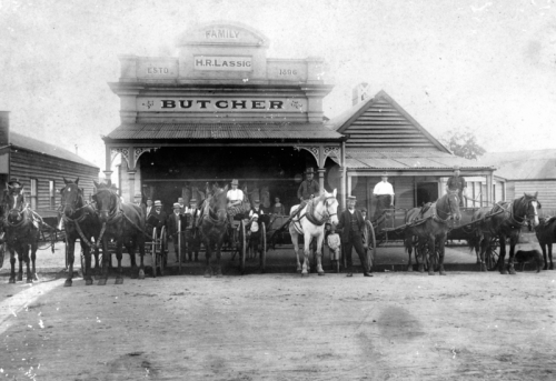 Staff with horses and carts outside H.R. Lassig's butcher shop, established 1896 (click to embiggen)